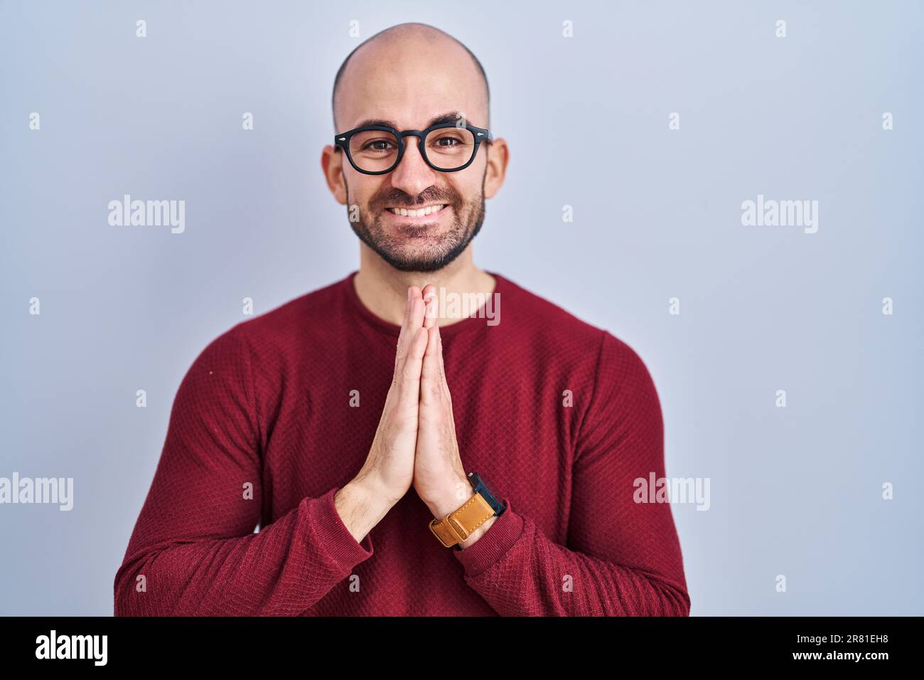 Young Bald Man With Beard Standing Over White Background Wearing Glasses Praying With Hands 4497