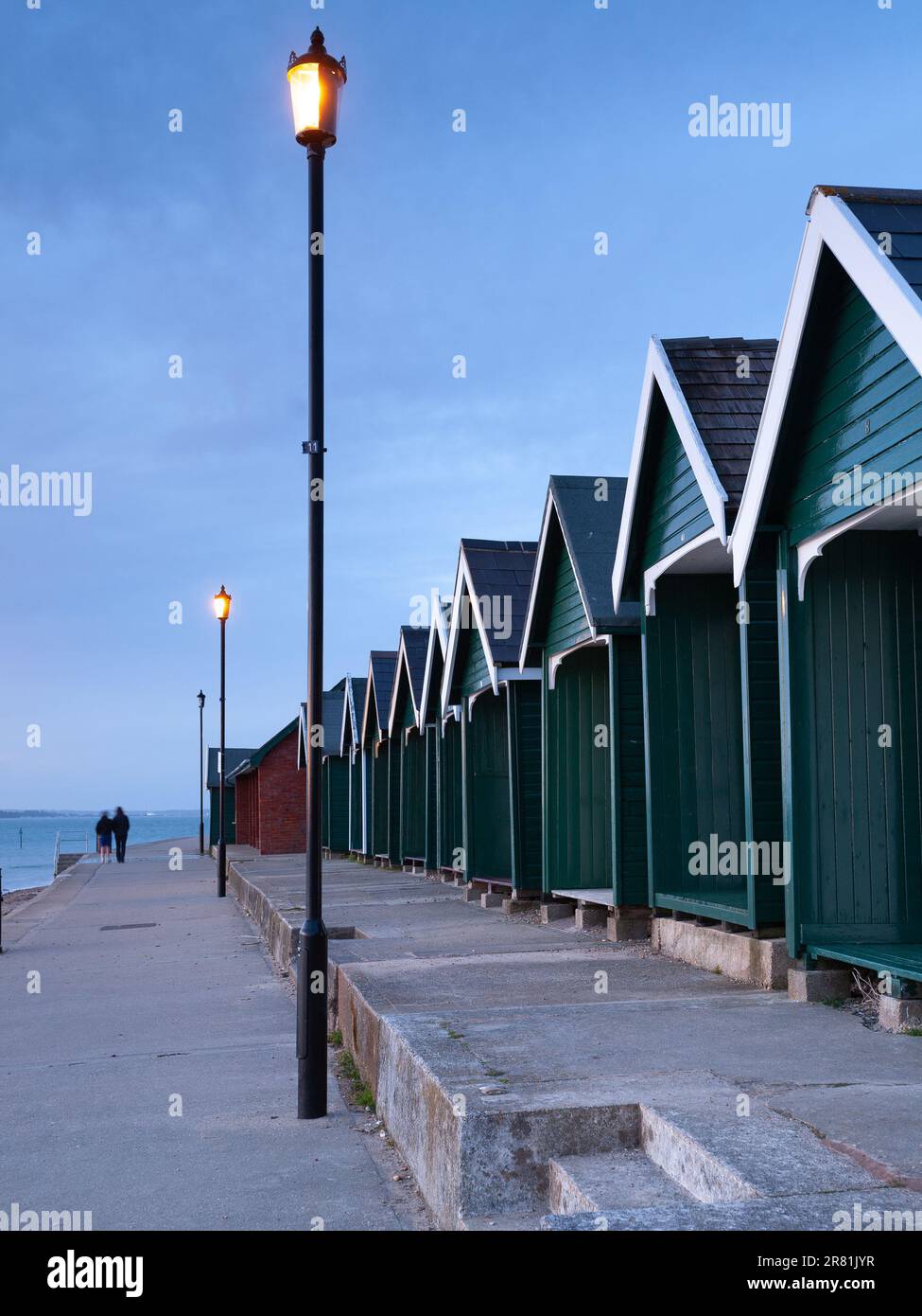 Quaint beach huts nestled on the shores of the picturesque Isle of Wight, where coastal charm meets seaside bliss Stock Photo