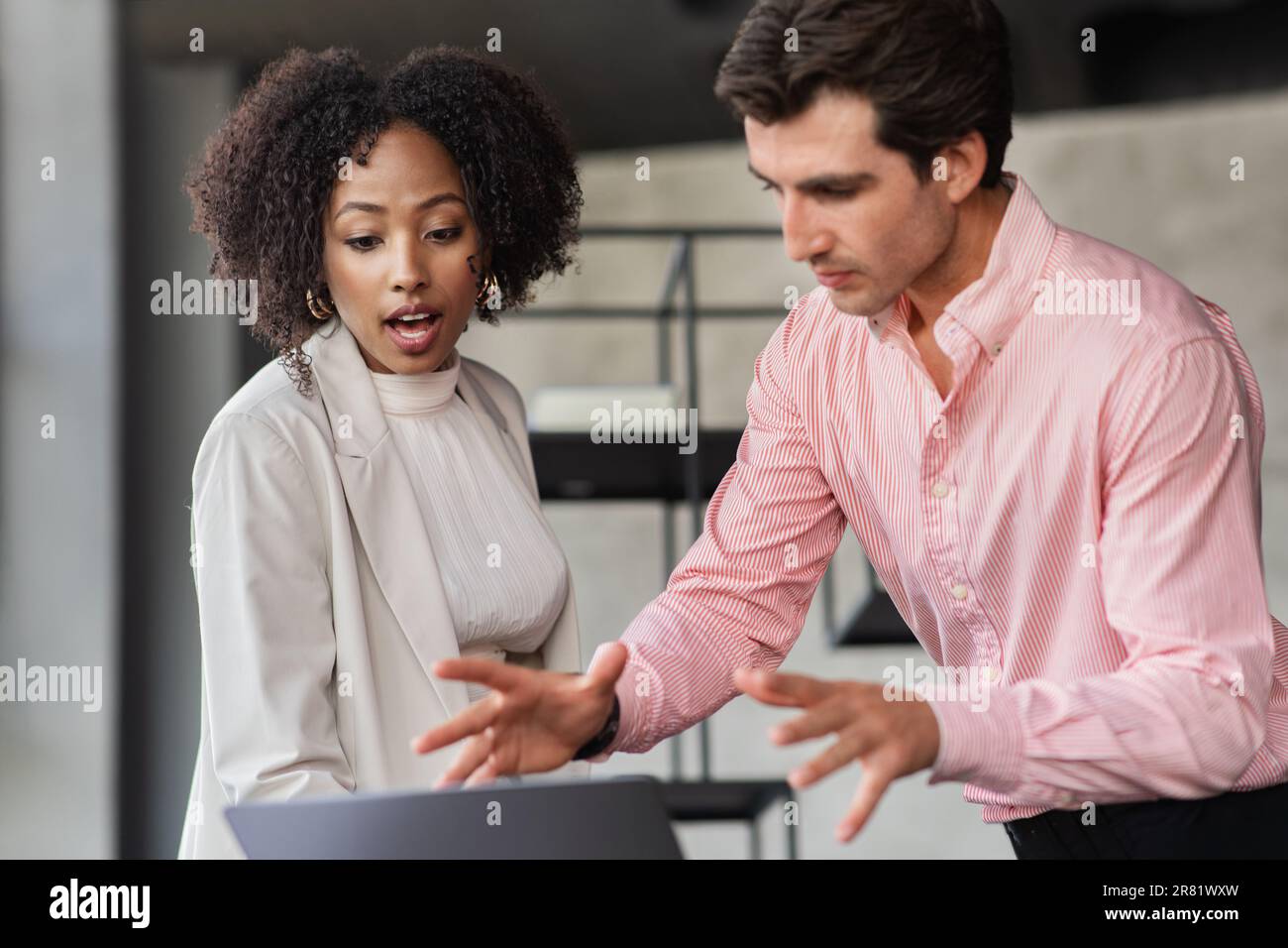 Enthusiastic multicultural employees working on project, office interior Stock Photo