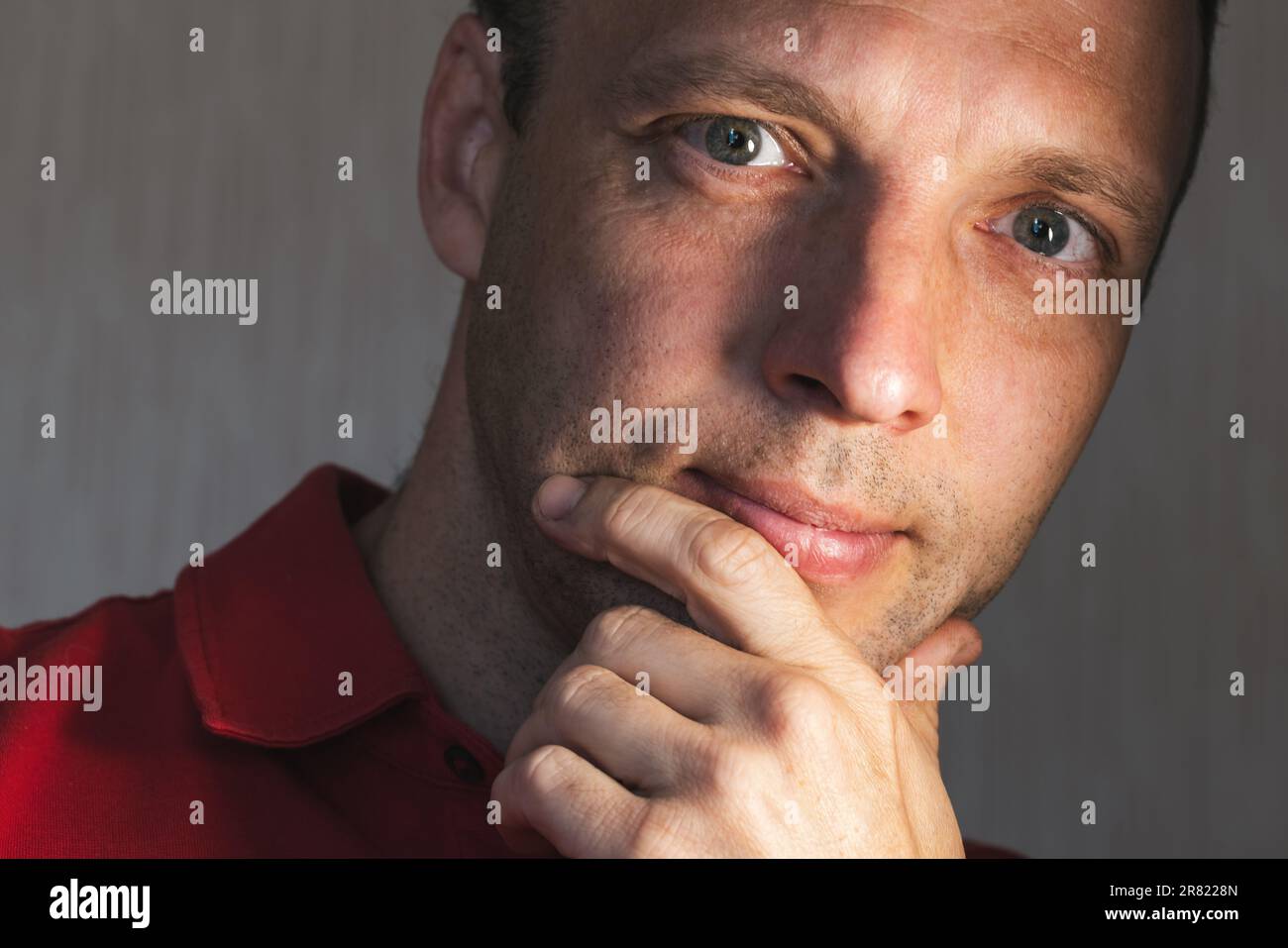Face portrait of positive young adult Caucasian man, studio photo with selective soft focus Stock Photo