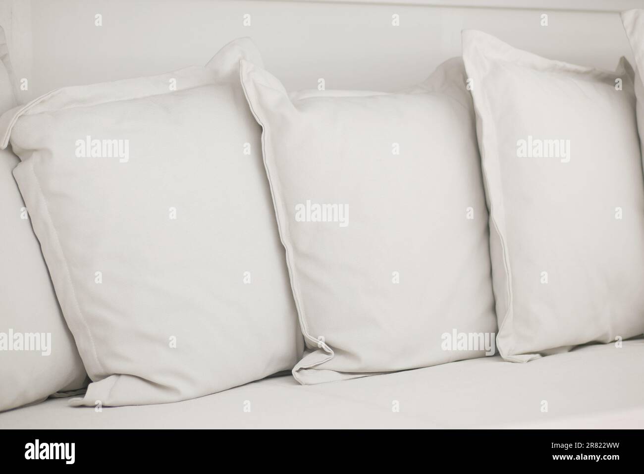 white pillow lined up on bed Stock Photo