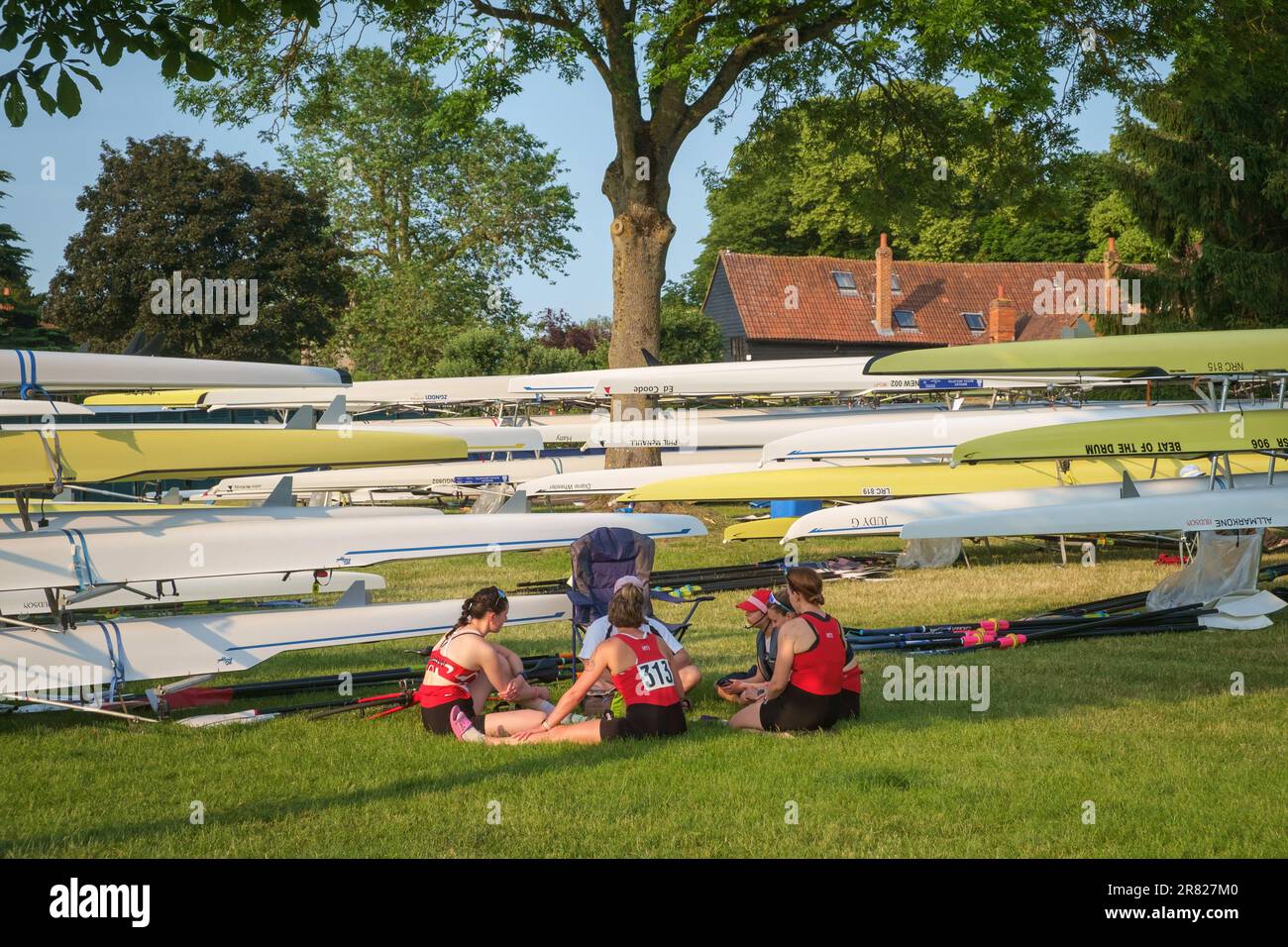 Competitors in red tops relax before a race at Henley Women's Regatta 2023, Henley-on-Thames Stock Photo
