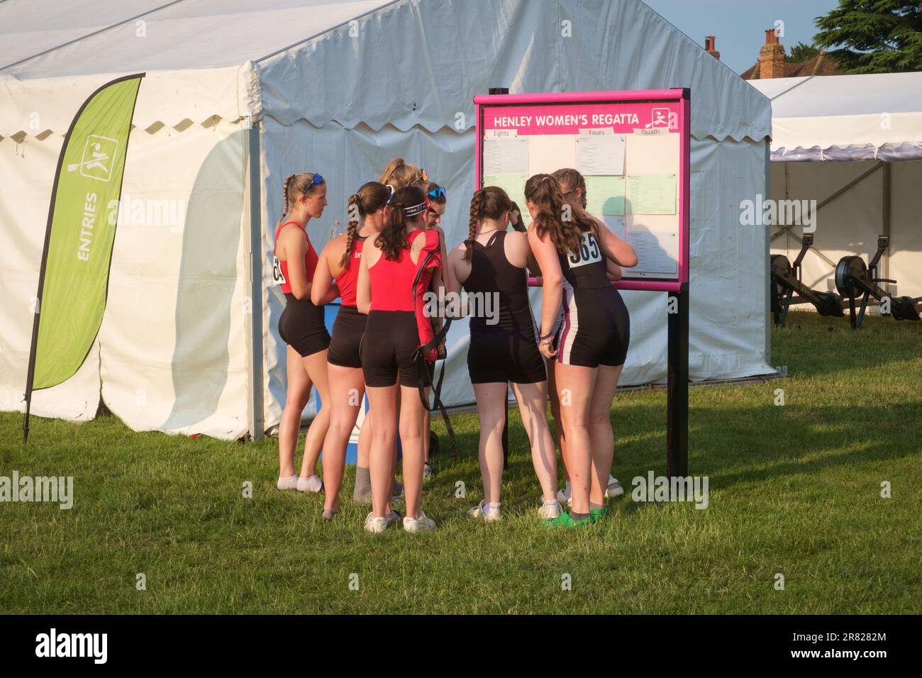 Young competitors check the results and schedule at Henley Women's Regatta 2023, Henley-on-Thames Stock Photo
