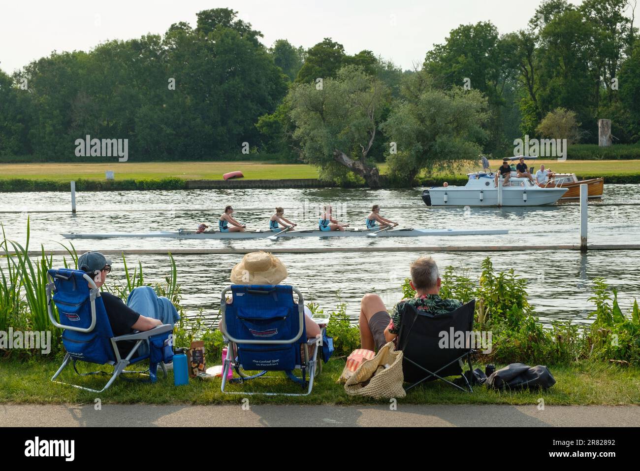 A family watch a race go by from the towpath at Henley Women's Regatta 2023, Henley-on-Thames Stock Photo