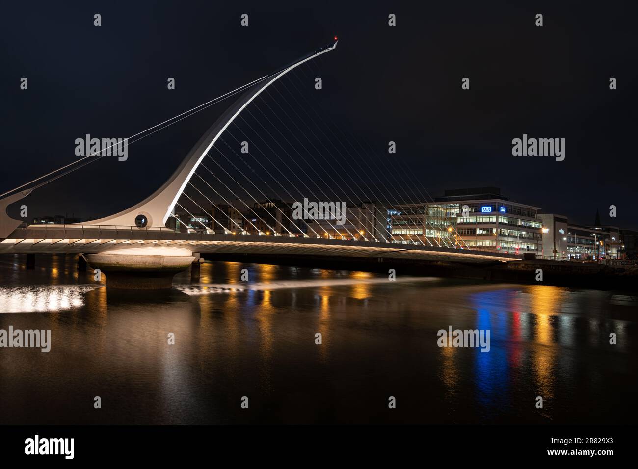 The Samuel Beckett Bridge over the River Liffey illuminated at night ...
