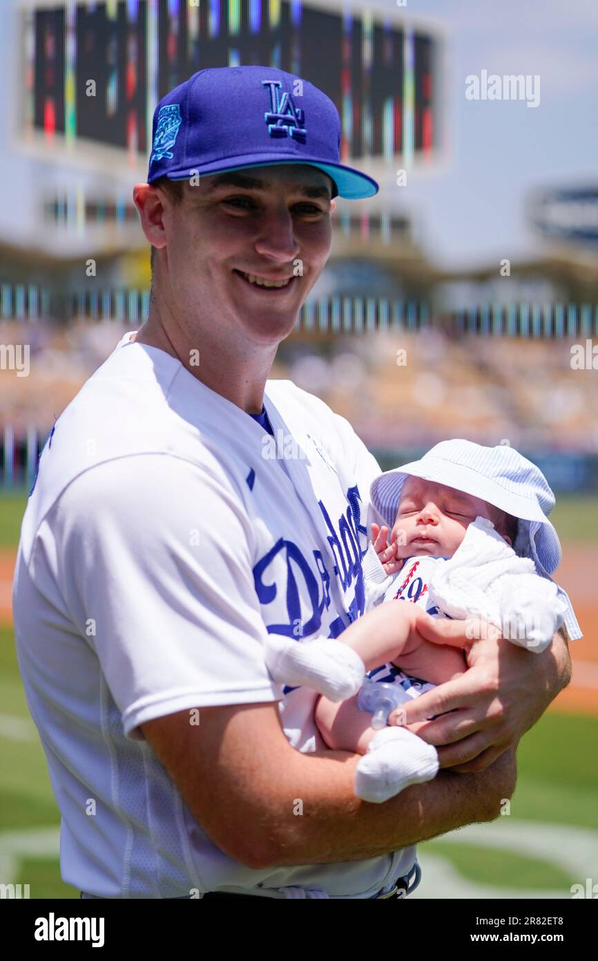 Los Angeles Dodgers relief pitcher Evan Phillips (59) holds his son