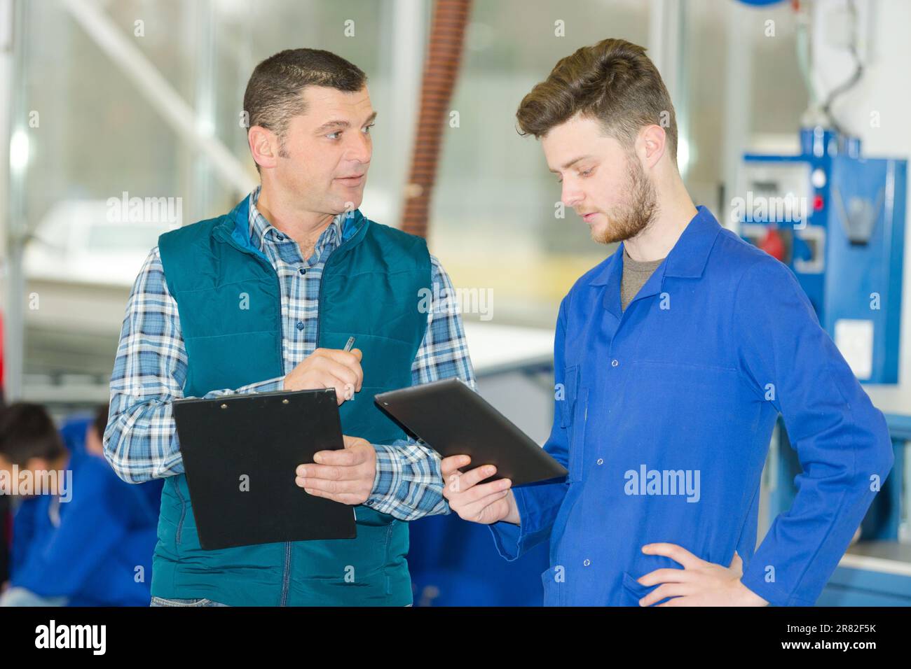 men working in a plant with tablet Stock Photo