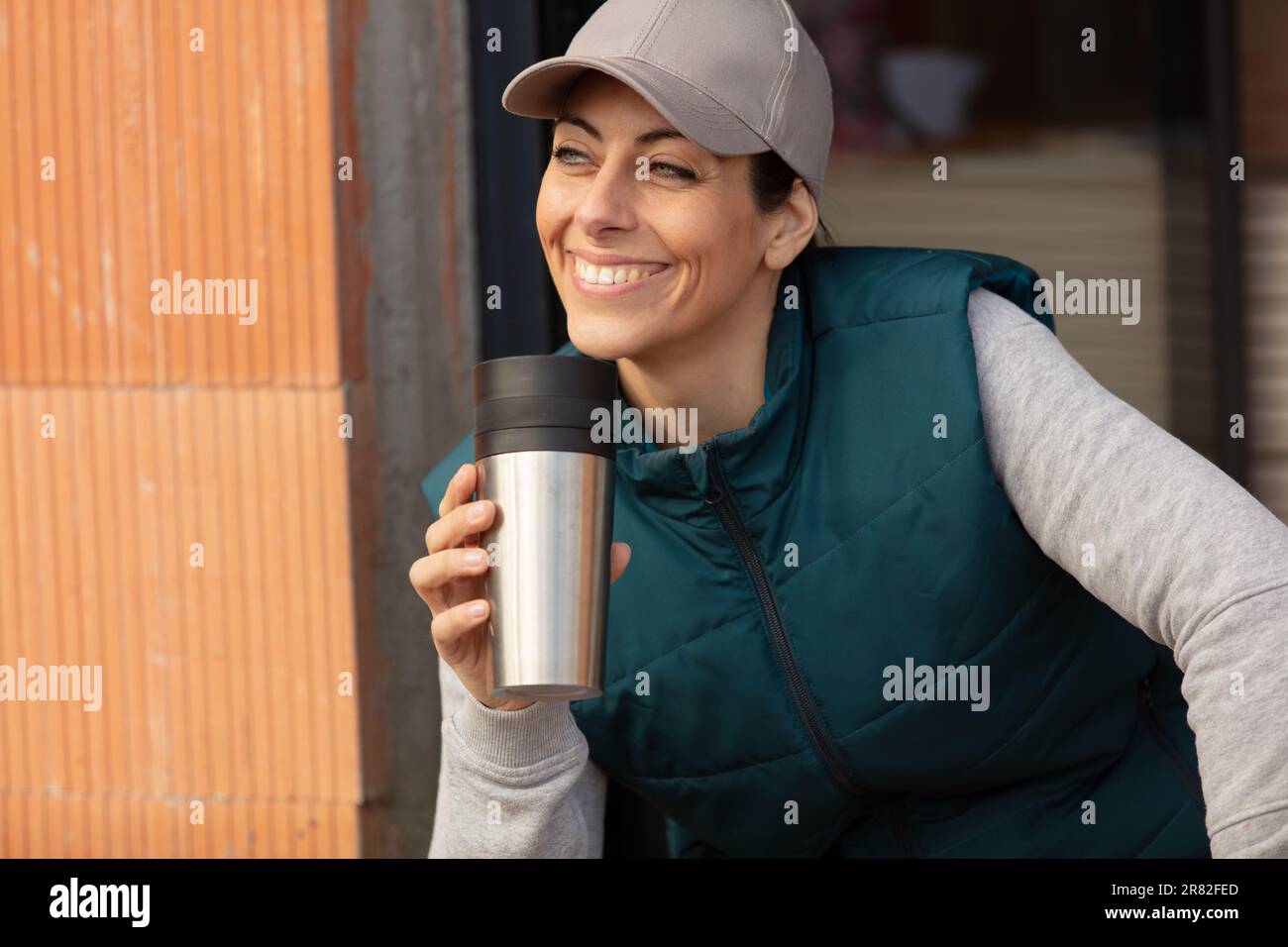 relaxed young builder drinking disposable coffee Stock Photo