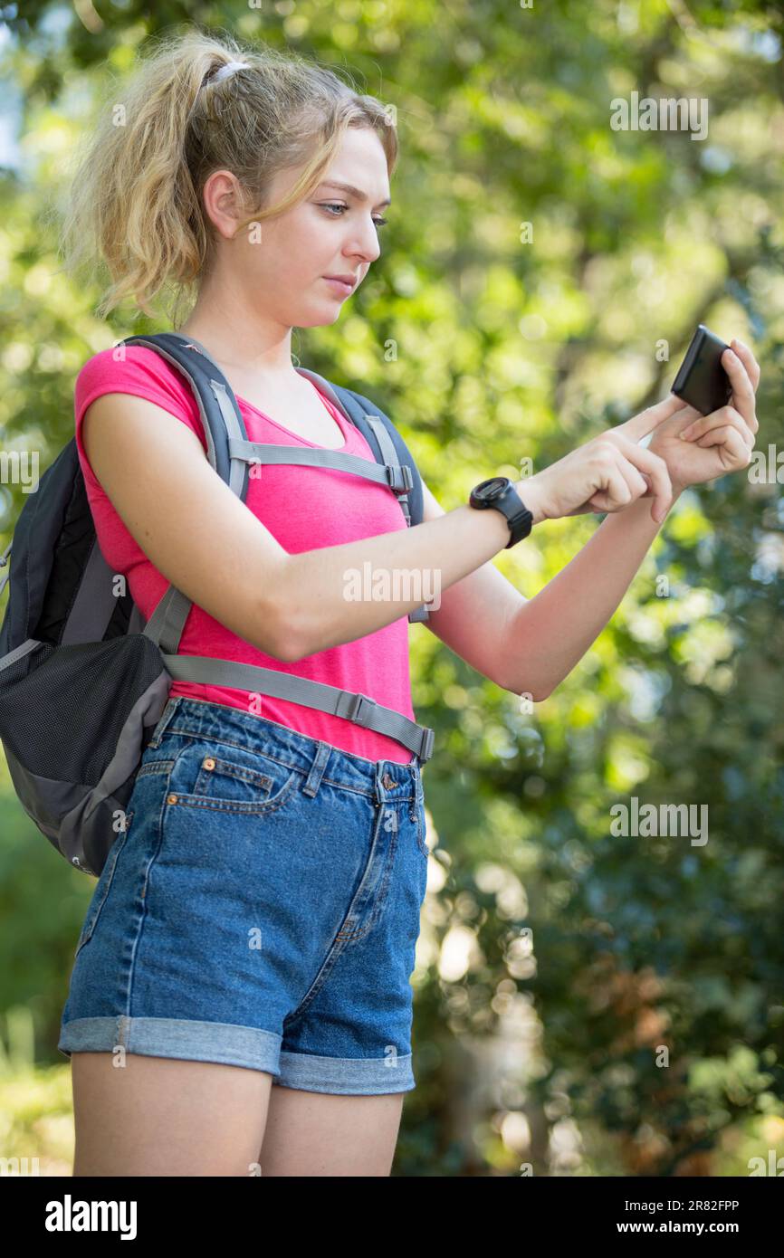 woman using a digital compass on mobile phone Stock Photo