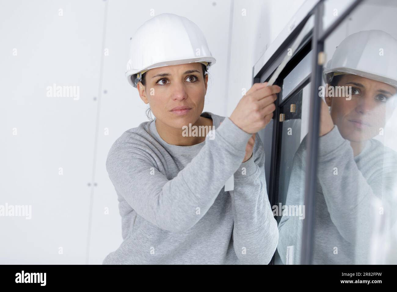 architect woman is checking windows on site Stock Photo