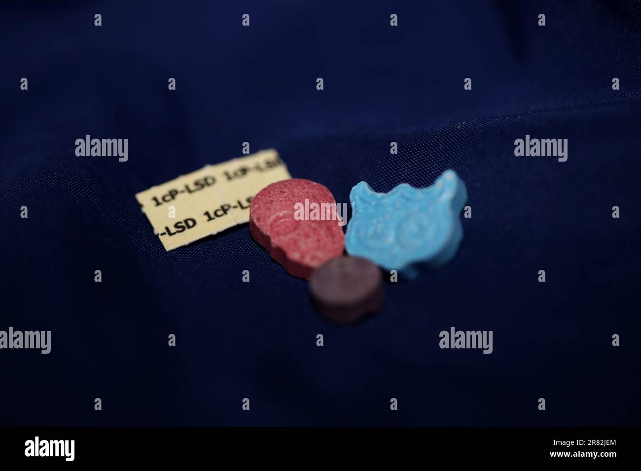 A mixed set of drugs and medicines pills containing mdma and lsd stick papers close up party animal backgrounds super high big size dance prints Stock Photo