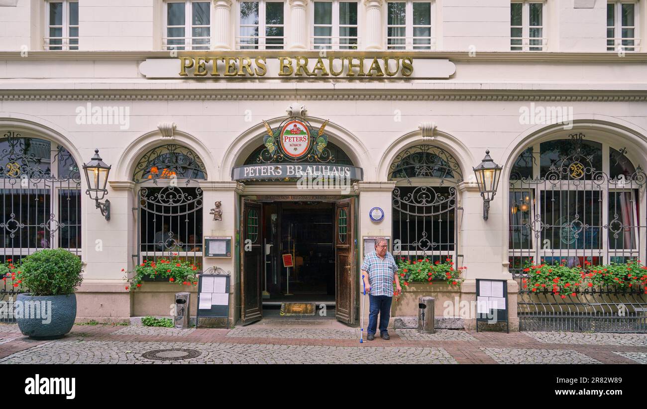 Historic beer hall, pub, called Peter's Brauhaus facade with man standing in front, in downtown