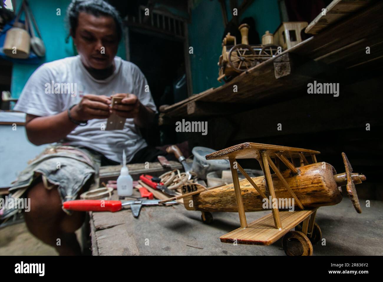 A craftsman makes automotive miniatures from bamboo in Bogor, West Java