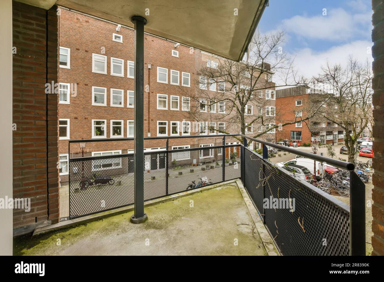 the view from an apartment balcony in south london, with cars parked on ...