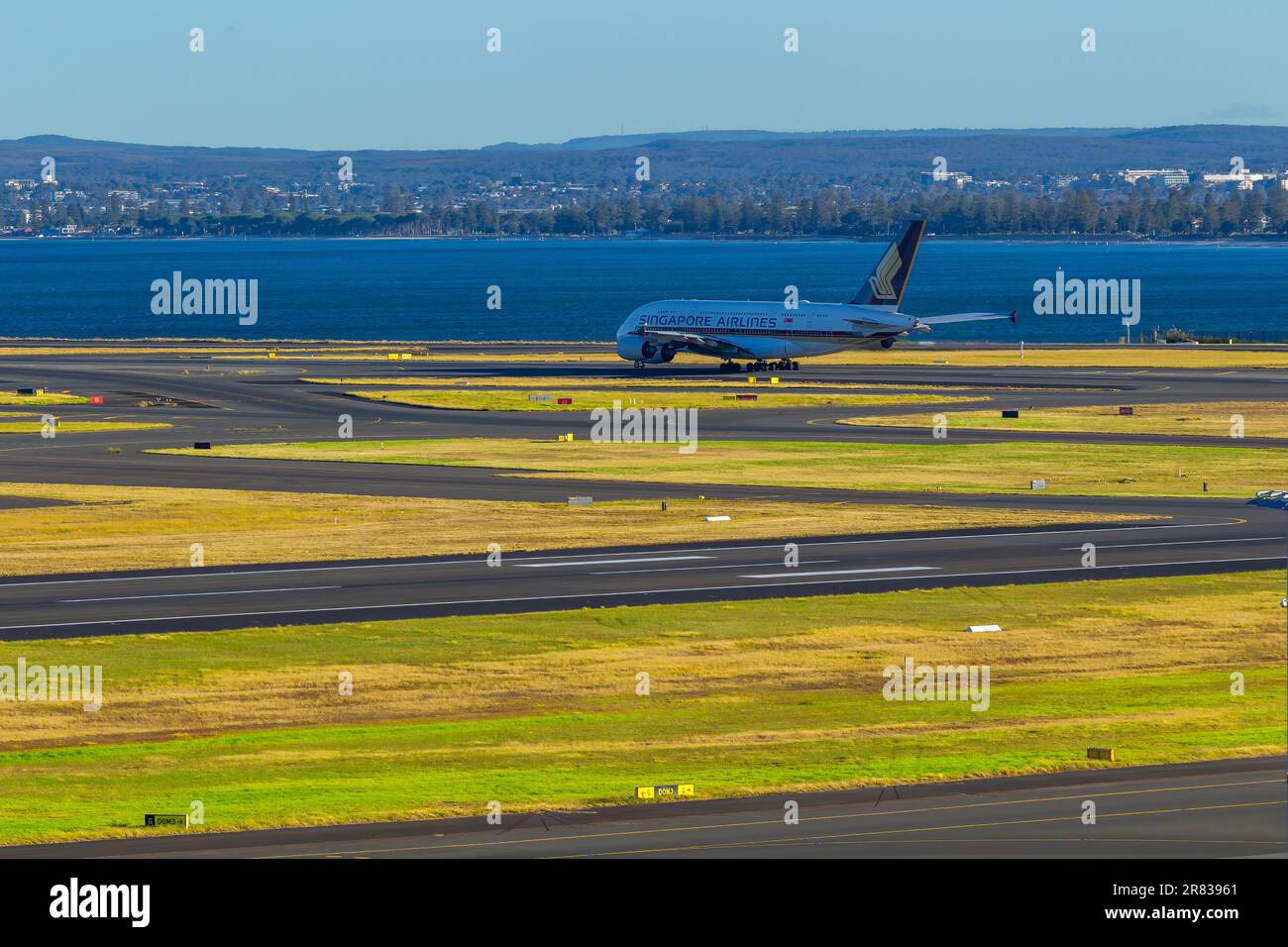 Aircraft movements at Sydney (Kingsford Smith) Airport in Australia, with Botany Bay in the background. Pictured: A Singapore Airlines Airbus A380 tax Stock Photo