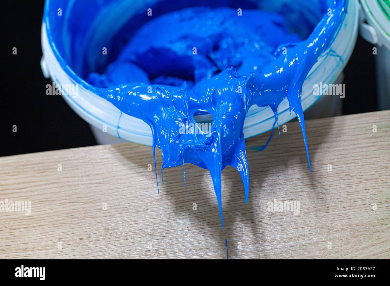 Blue paint dripping from white barrel. plastisol ink is used for
