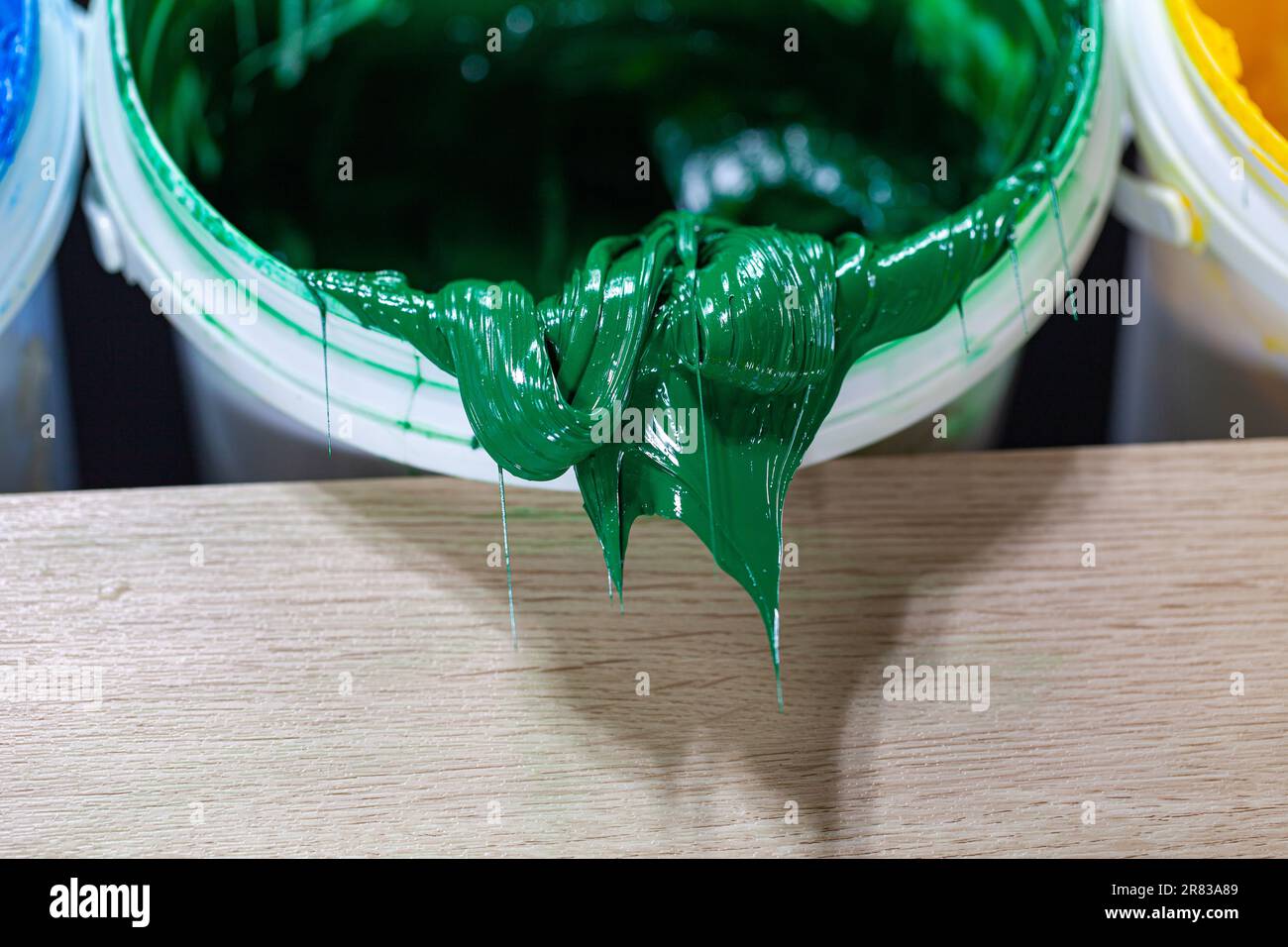 Green paint dripping from white barrel. plastisol ink is used for