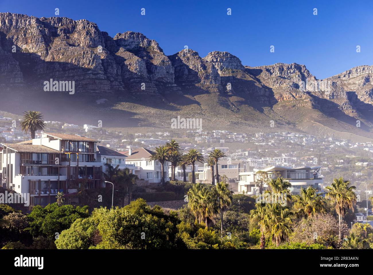 View of Camps Bay with Twelve Apostles in the background - Cape Town, South Africa Stock Photo