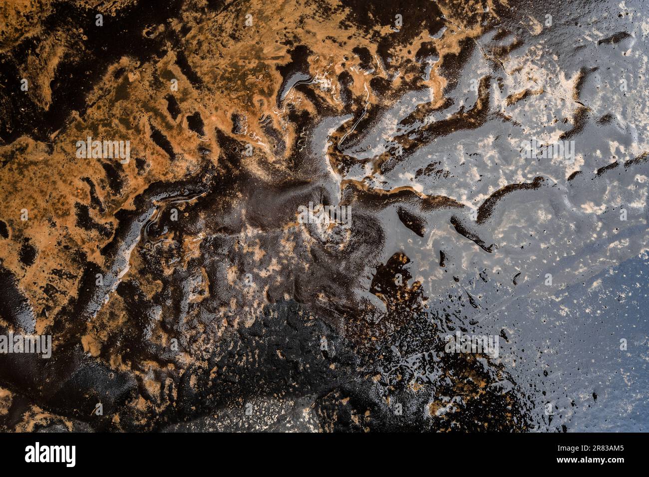 Rainwater washes away the soil and creates shapes resembling running horses. Stock Photo