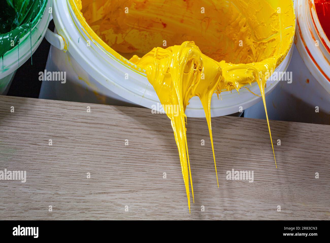 Yellow paint dripping from white barrel. plastisol ink is used for