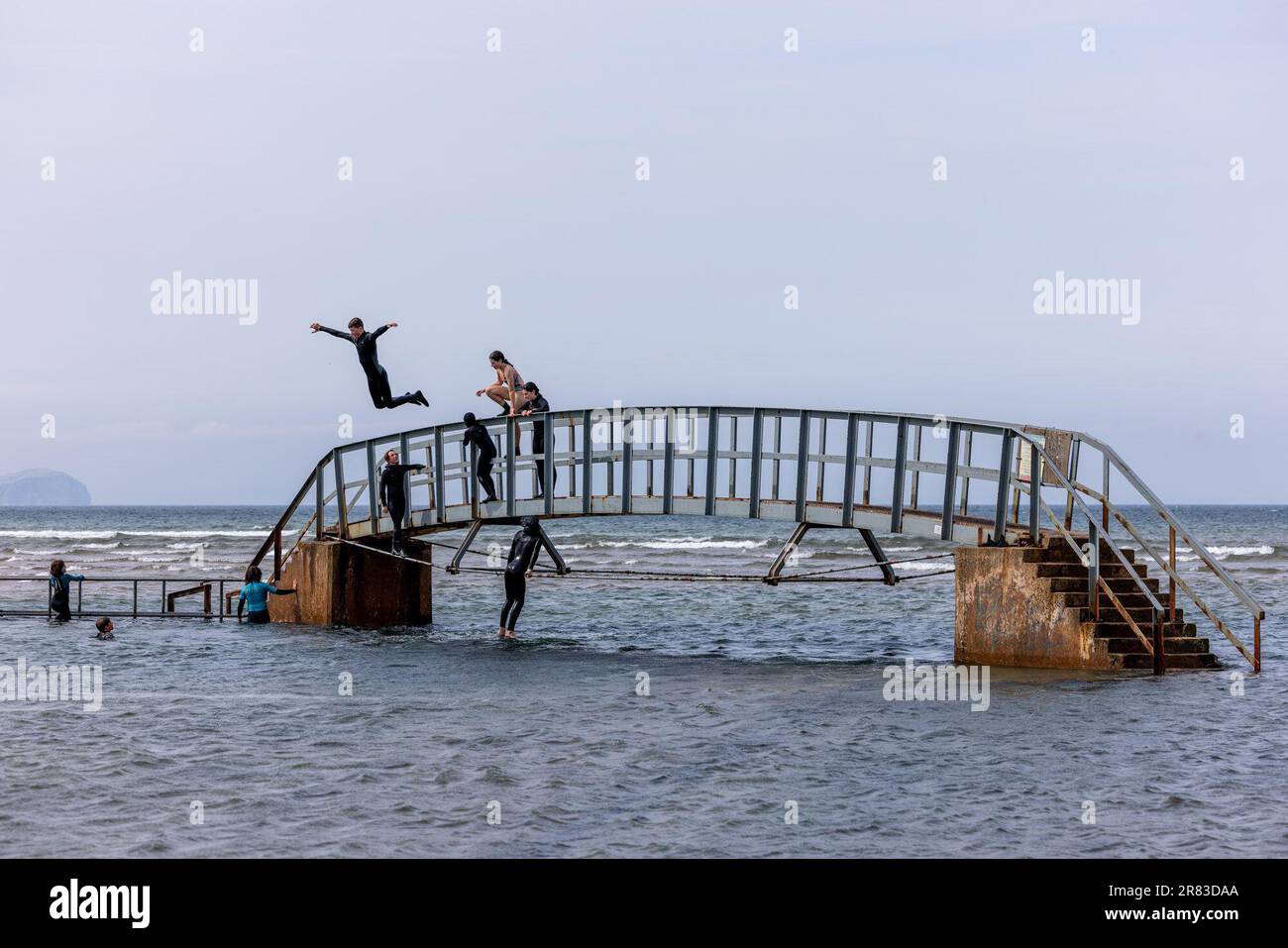 Dunbar, United Kingdom. 18 June, 2023 Pictured: Children jump from the famous “Bridge to Nowhere” at Belhaven Bay in Dunbar, East Lothian. Credit: Rich Dyson/Alamy Live News Stock Photo