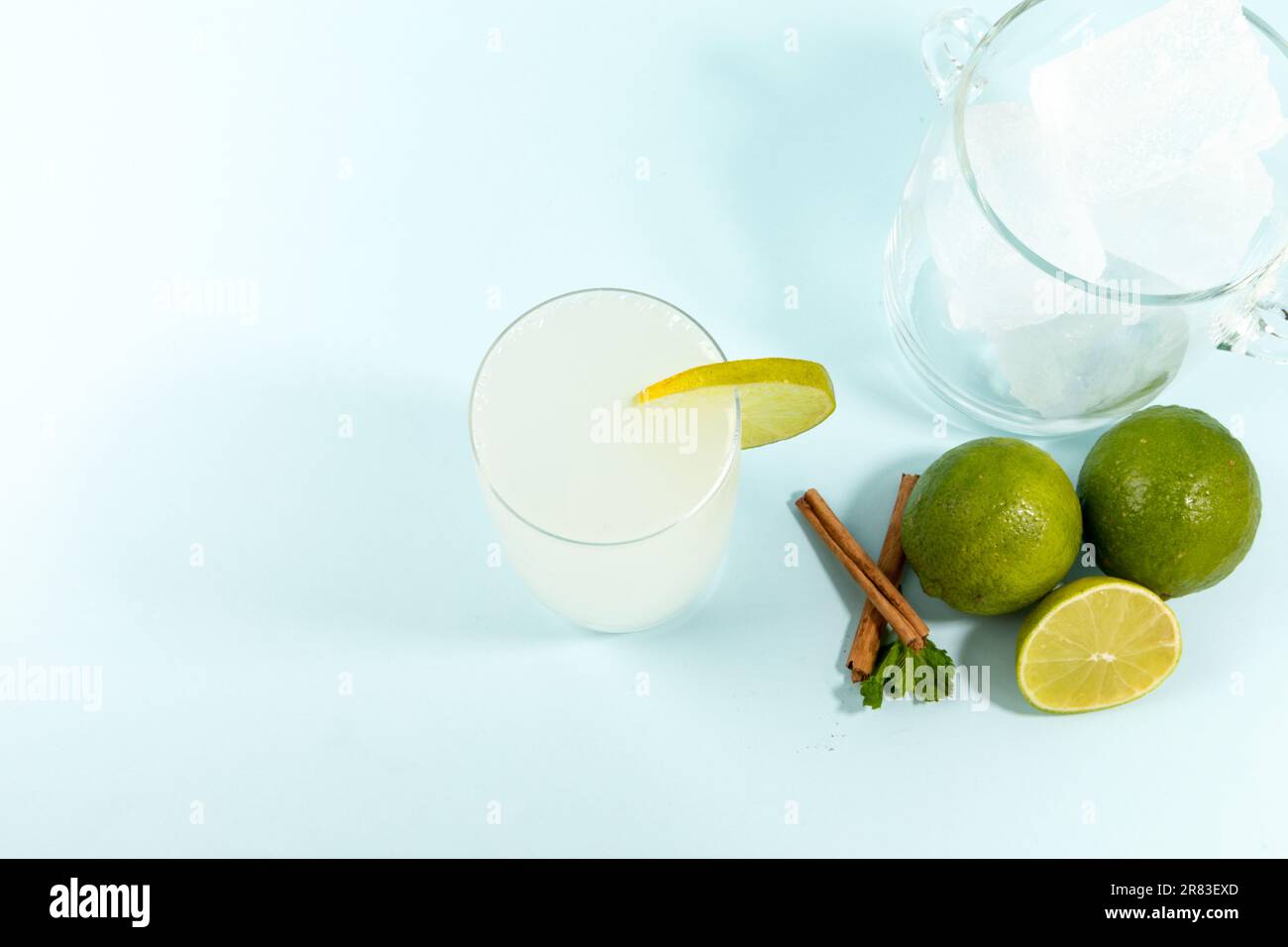 Summer refreshing lemonade drink or alcoholic cocktail on bright cyan ...