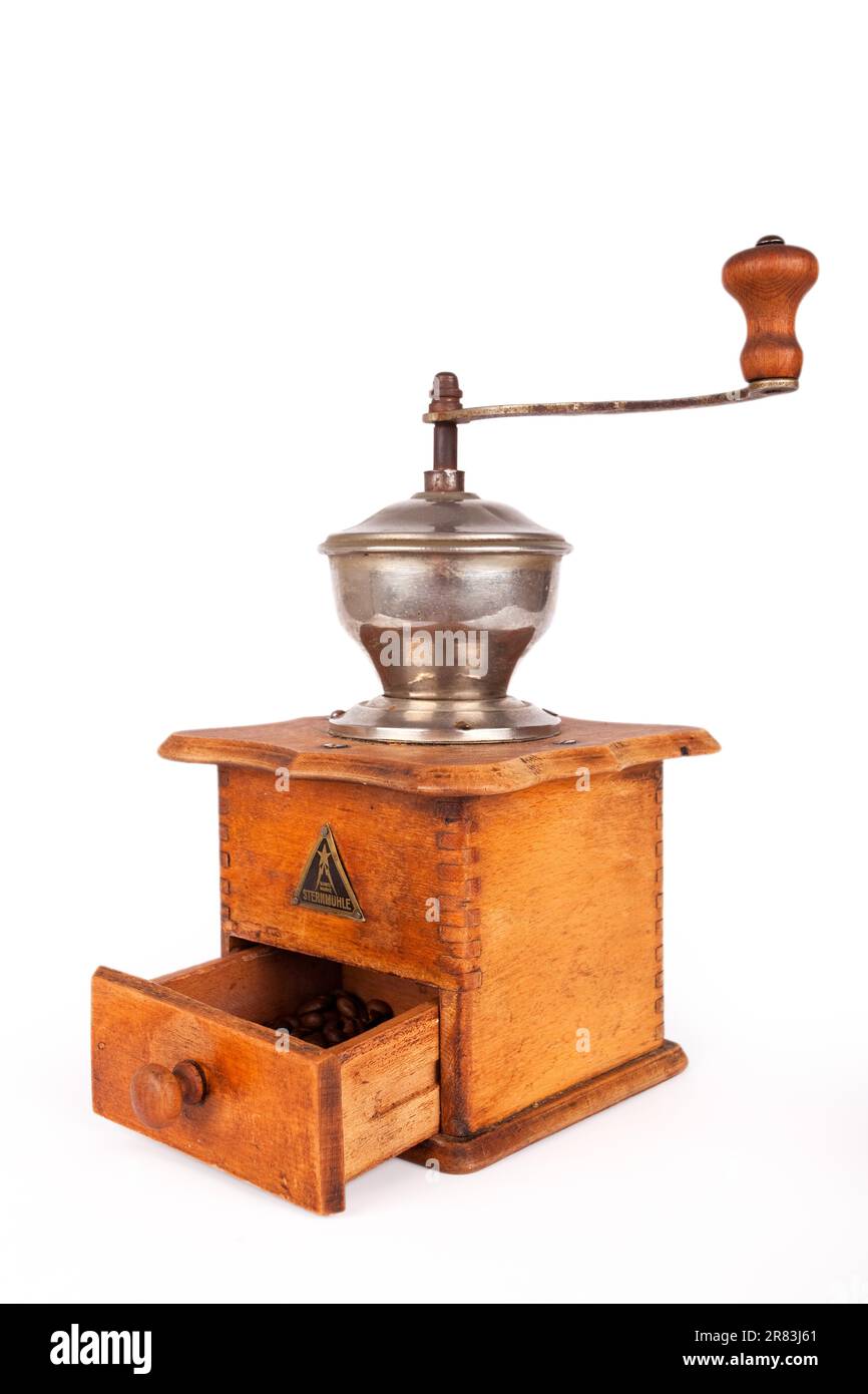 Old broken coffee grinder on white background Stock Photo Alamy