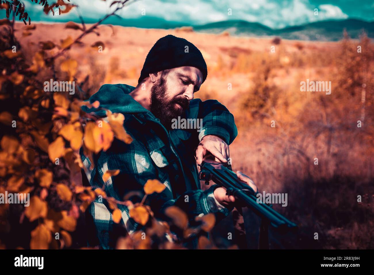 Hunter with shotgun gun on hunt. Autumn hunting season. Closed and open