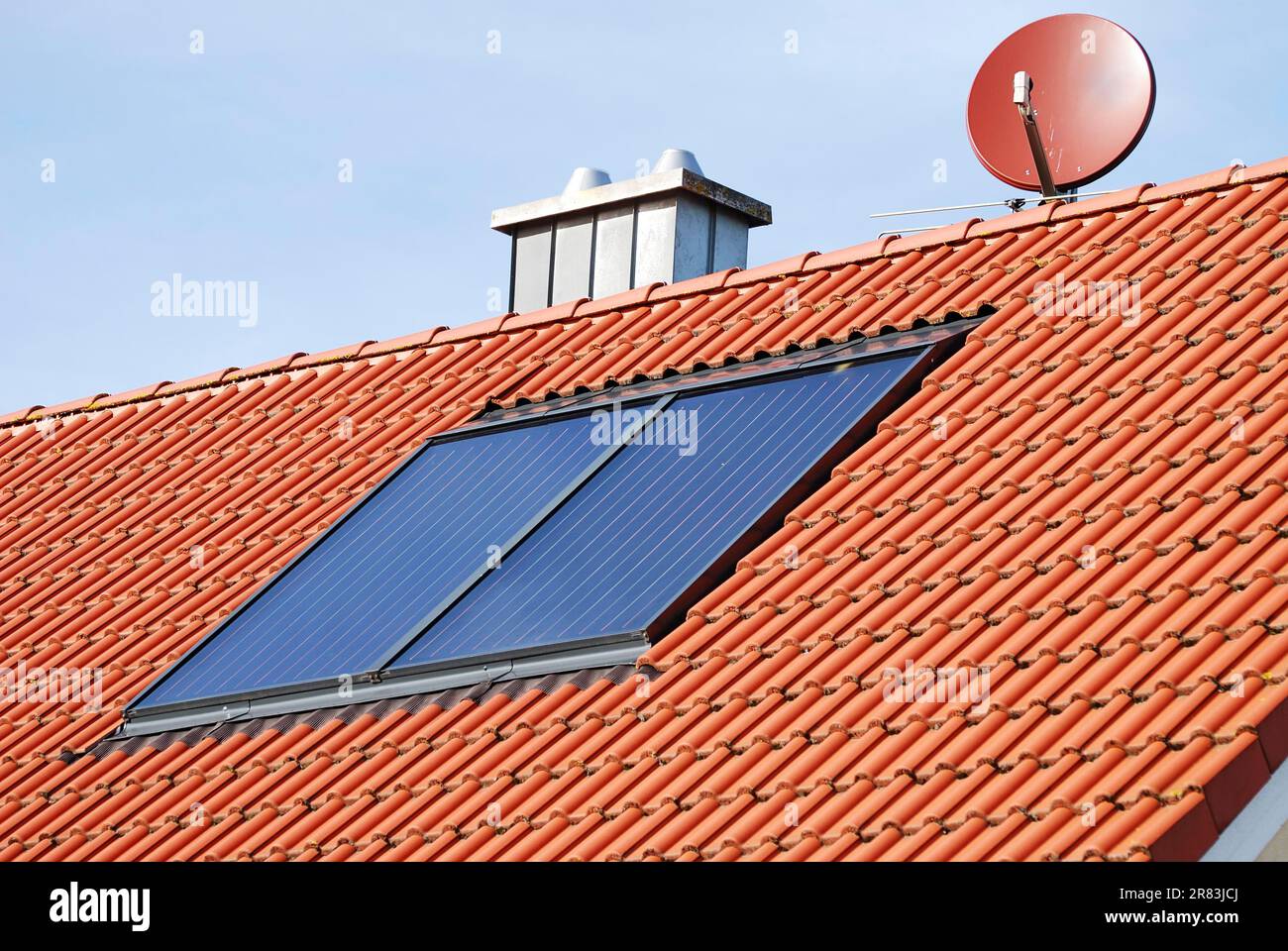 Solar heating system on the roof of a house Stock Photo