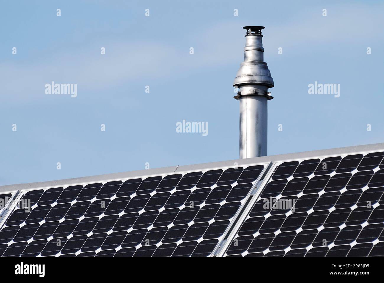 Chimney and regenerative energy with photovoltaic cells Stock Photo