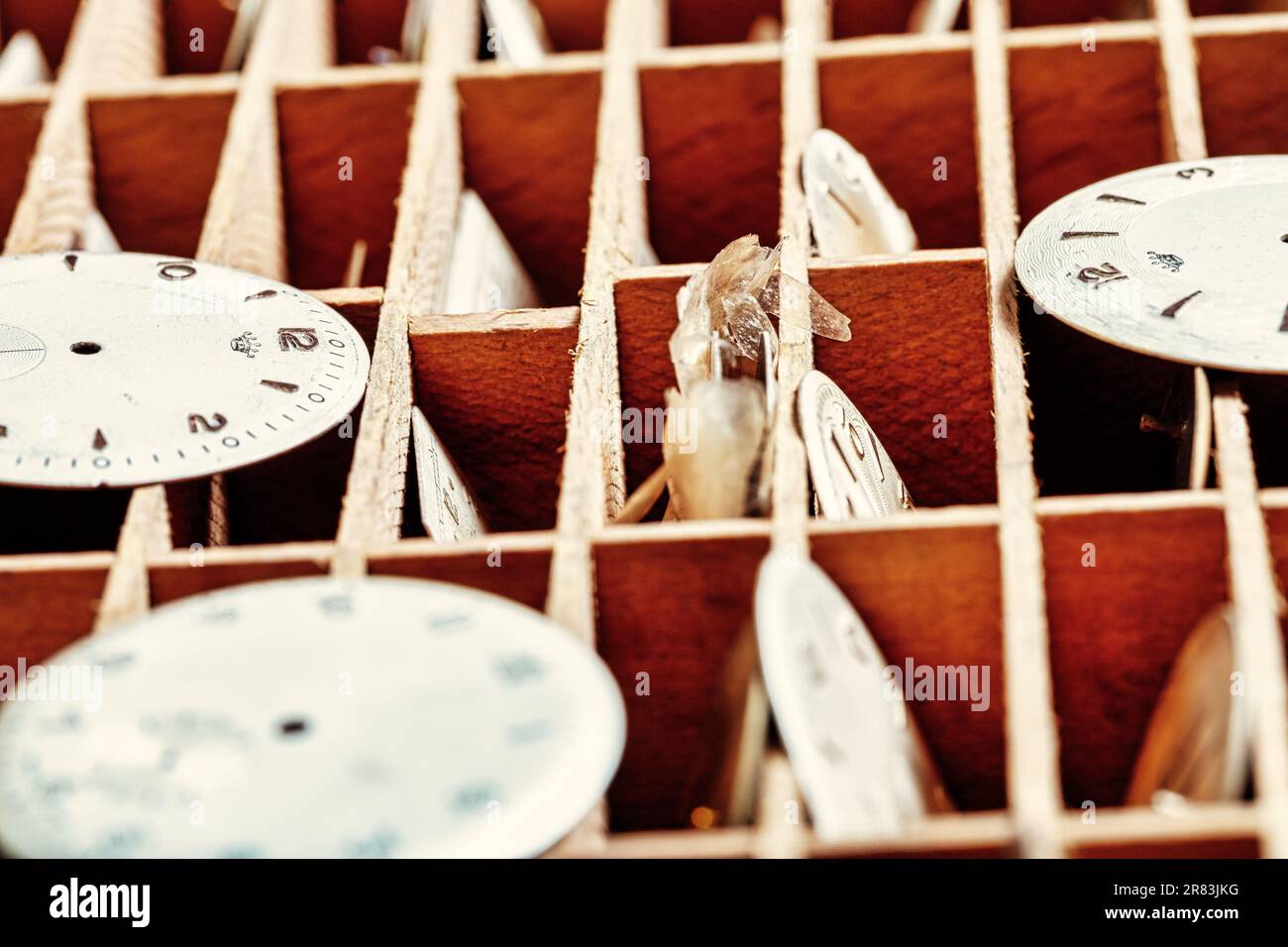 In a steampunk setting, a craftsman's table with watches, gears, springs illustrate the precise mechanical work and the refinement of horology as both Stock Photo