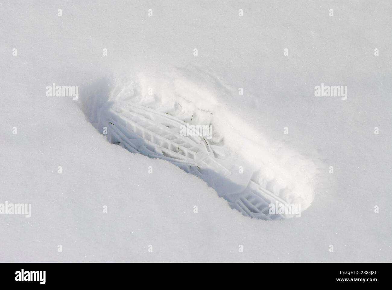 Footprint of a boot in the snow Stock Photo