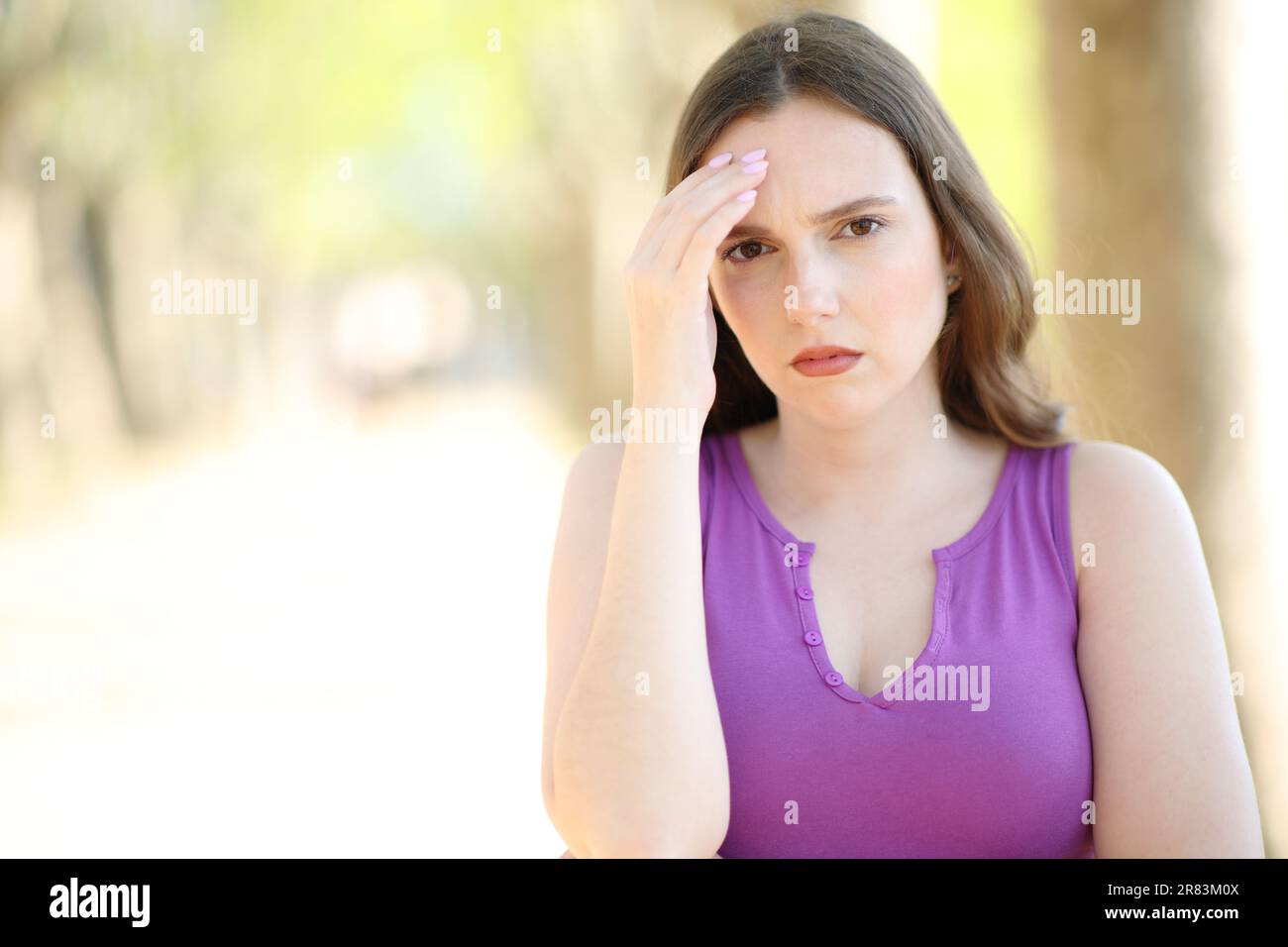 Front view portrait of a worried woman complaining looking at camera Stock Photo