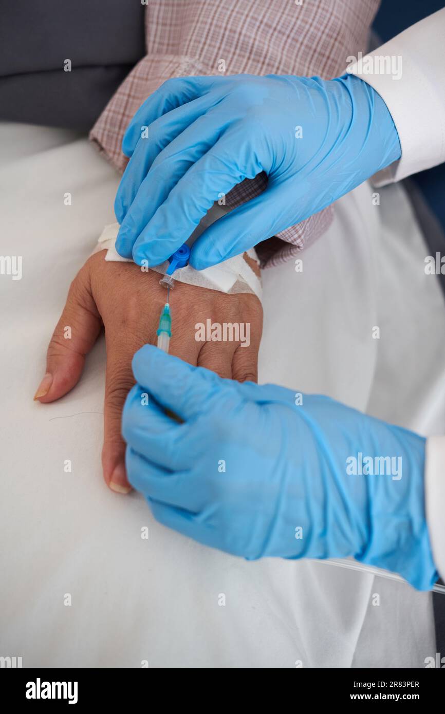 Hands of doctor removing intravenous catheter after finishing medical