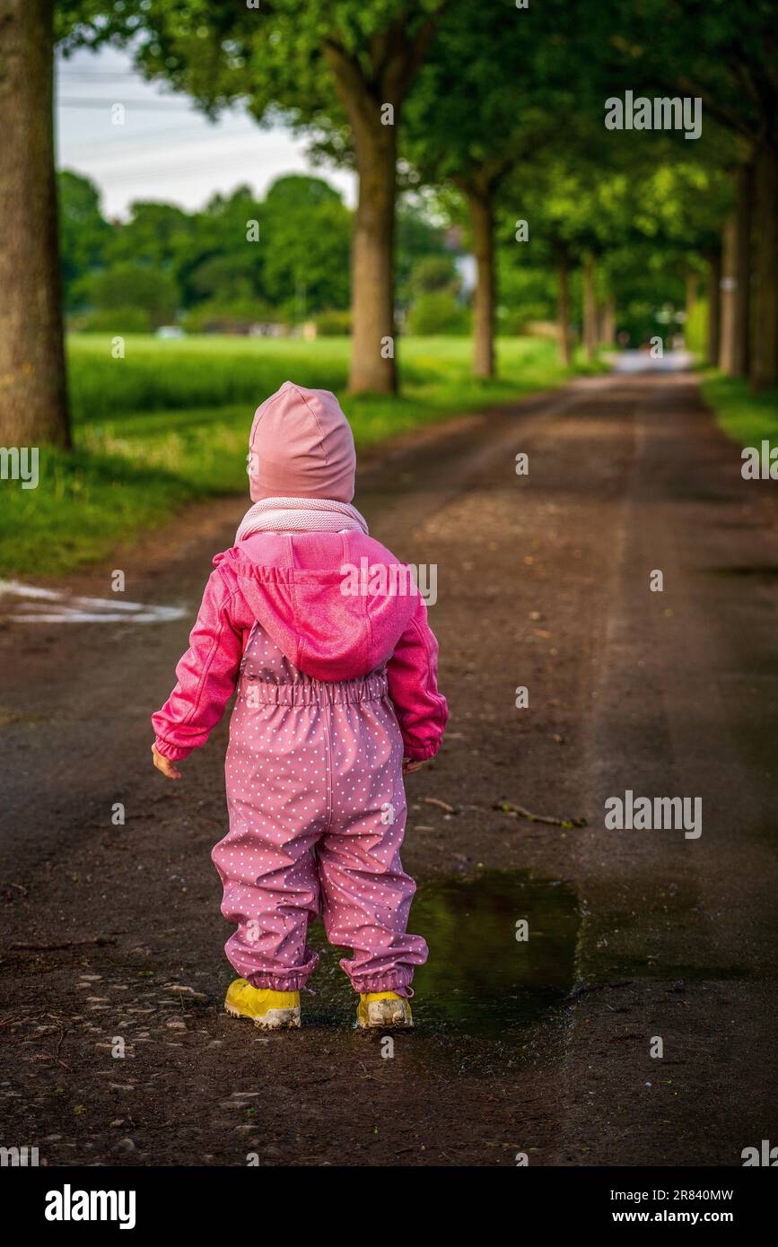 Child with yellow rubber boots on the country lane Stock Photo Alamy