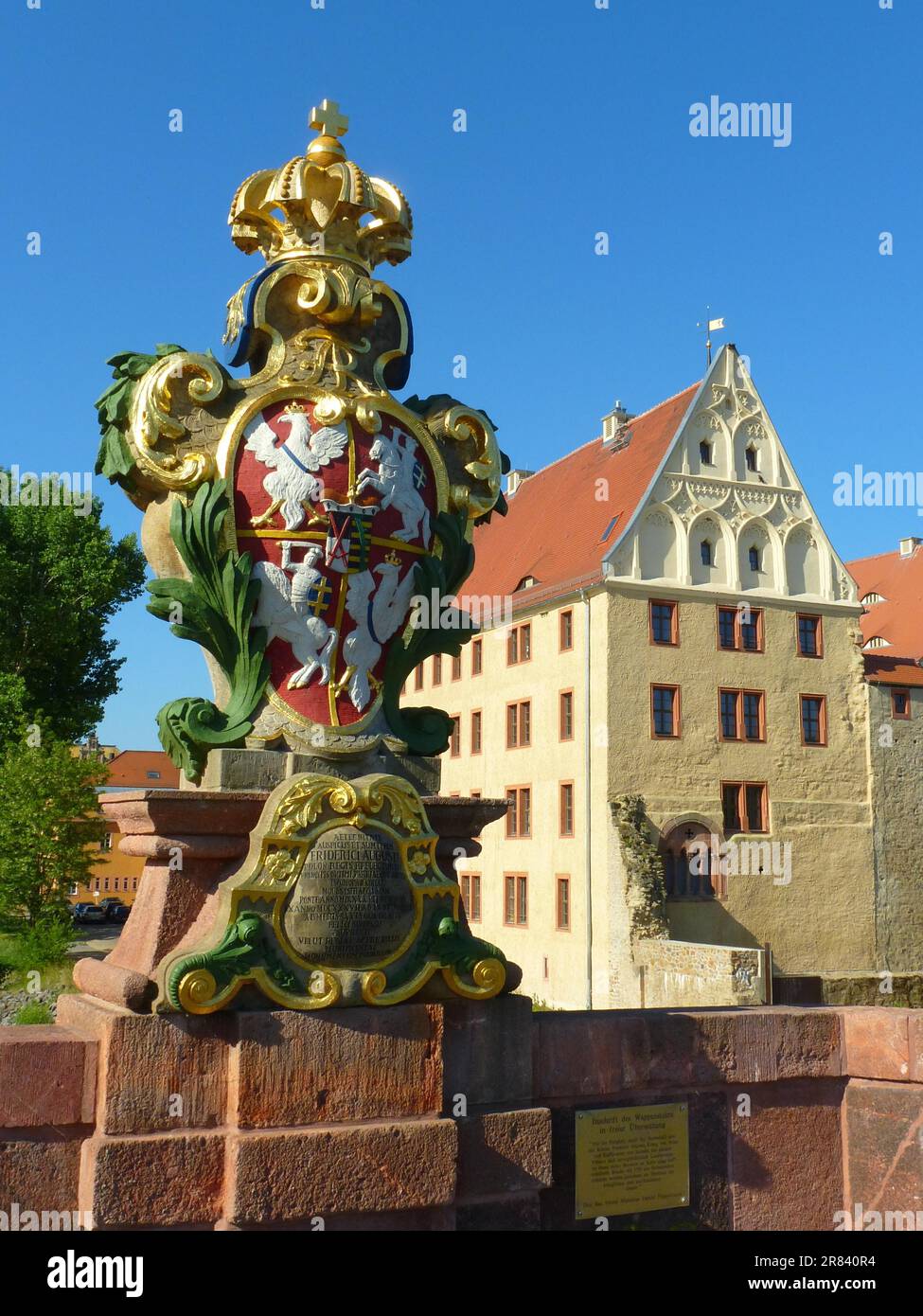 Arms stone on the Poeppelmann bridge in Grimma in Saxony with Palace Stock Photo