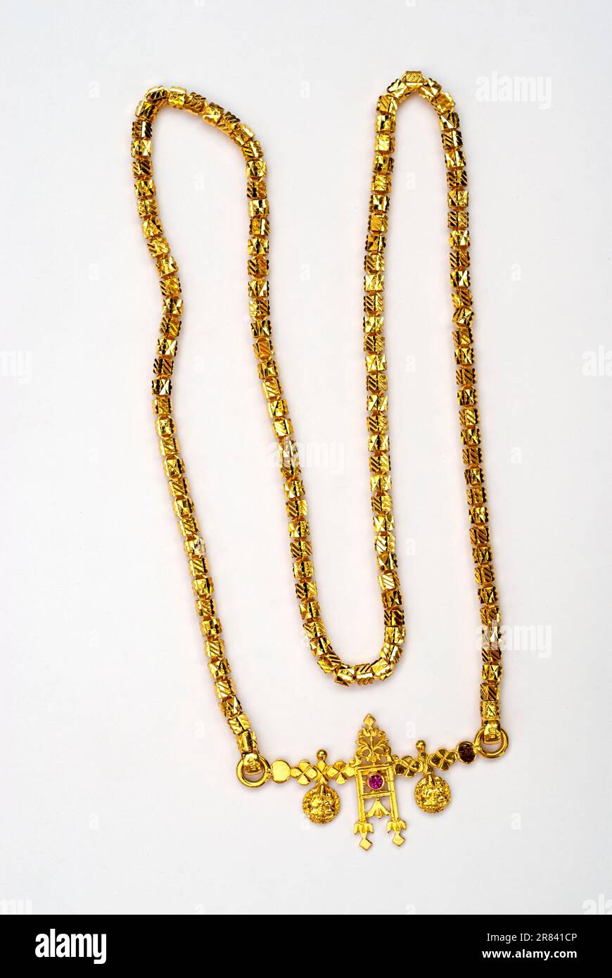 Gold chain with Chettinad Mangalya, thali worn on neck on white ...