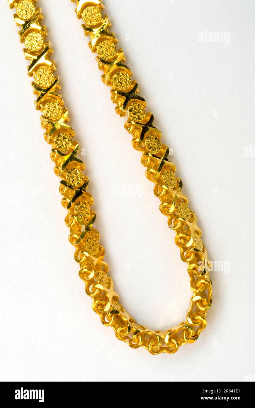 Details of gold chain worn on neck on white background Studio shot, Tamil Nadu, South India