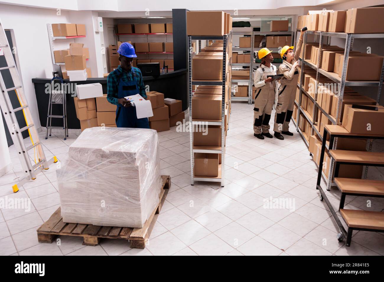 Industrial warehouse coworkers doing freight inventory, managing big