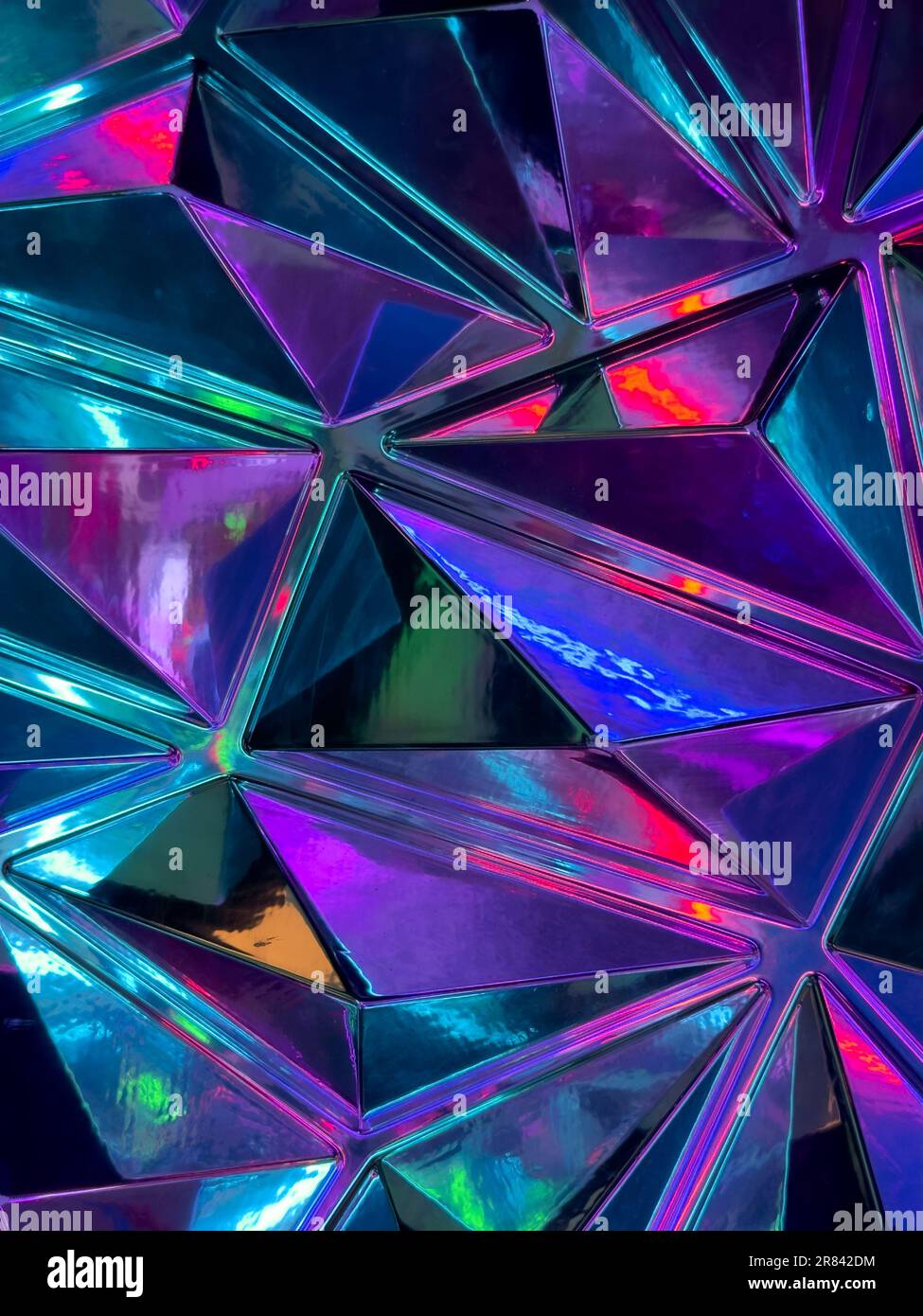 A colorful glass texture with various shapes and hues, shining brightly