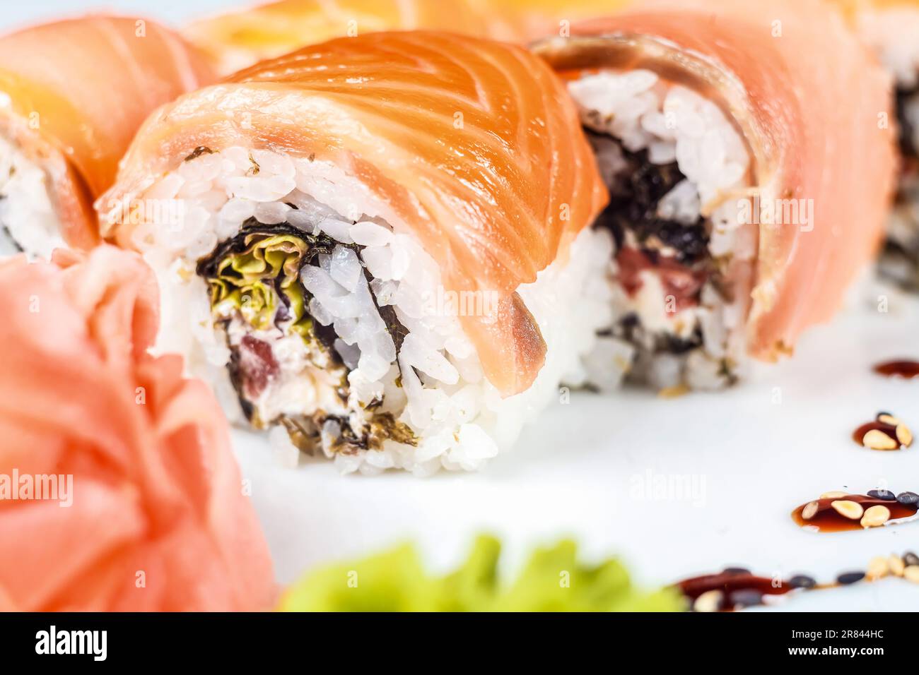 Fresh and flavorful Asian food, such as the California Roll with Salmon and Rice, awaits your taste buds! Stock Photo