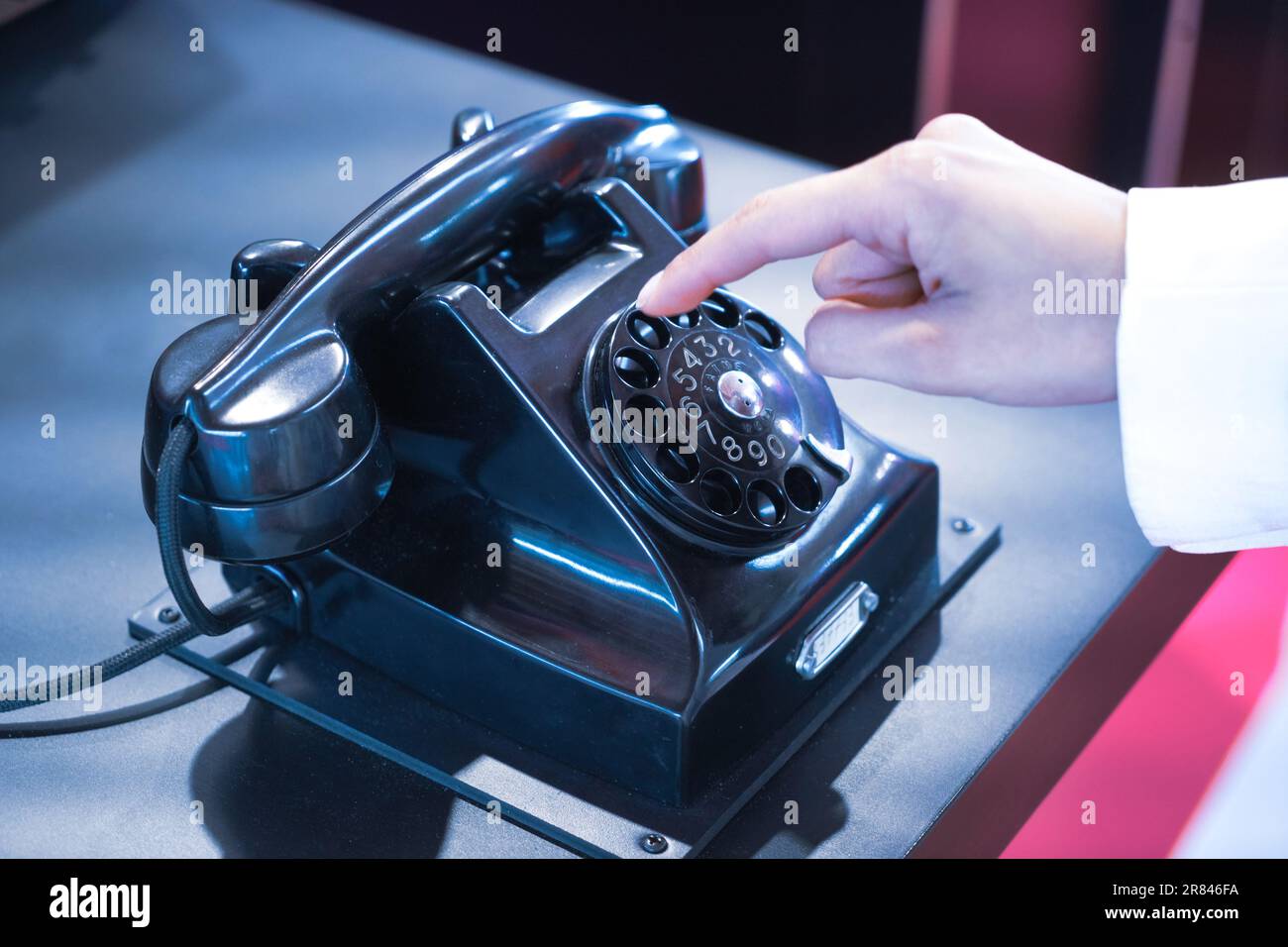 An old bakelite dial telephone with a finger dial Stock Photo
