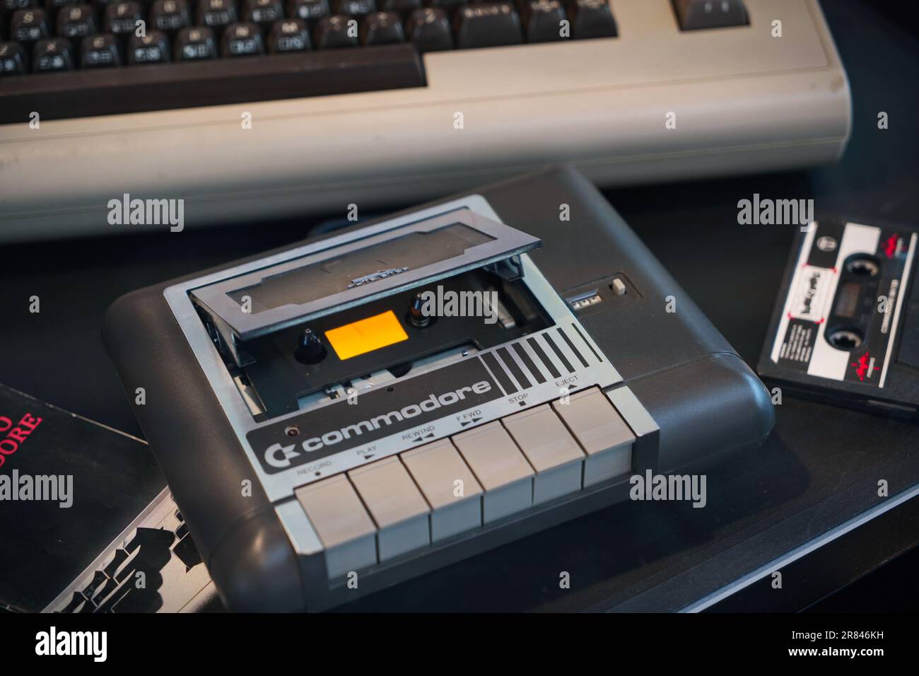 Rimini, Italy, June 2023: a vintage console Commodore 64 with an old tape cassette in it to play a video game. Stock Photo