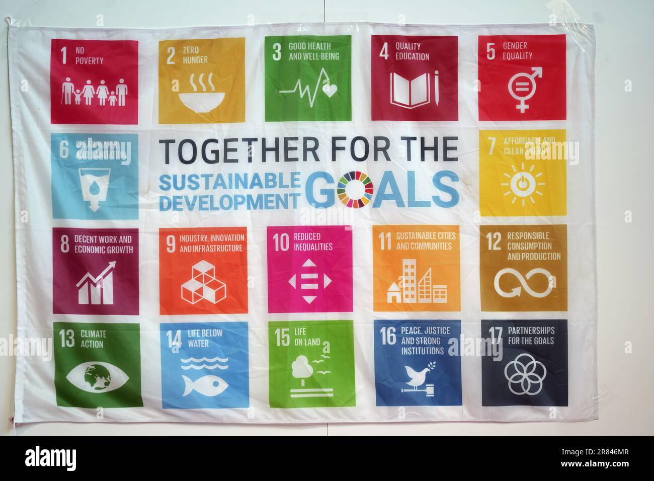 Rimini, Italy, June 2023: Flag of goals for addressing poverty worldwide and realizing sustainable development. SDGs Stock Photo