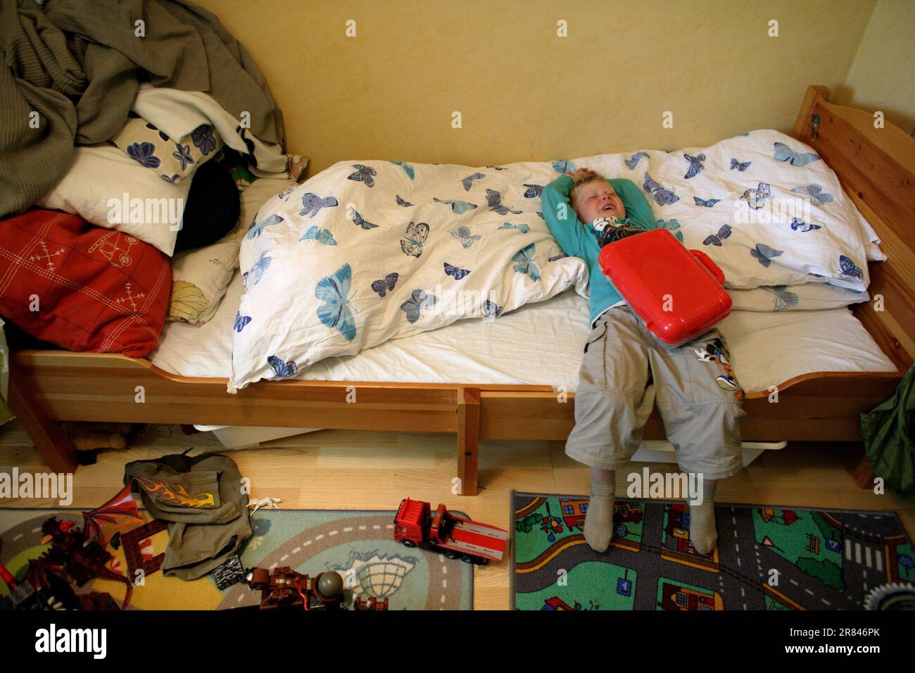 An autistic child throws a temper tantrum on his bed in Stockholm