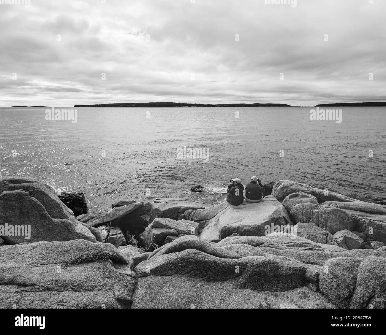 Couple sitting on beach Black and White Stock Photos & Images - Alamy
