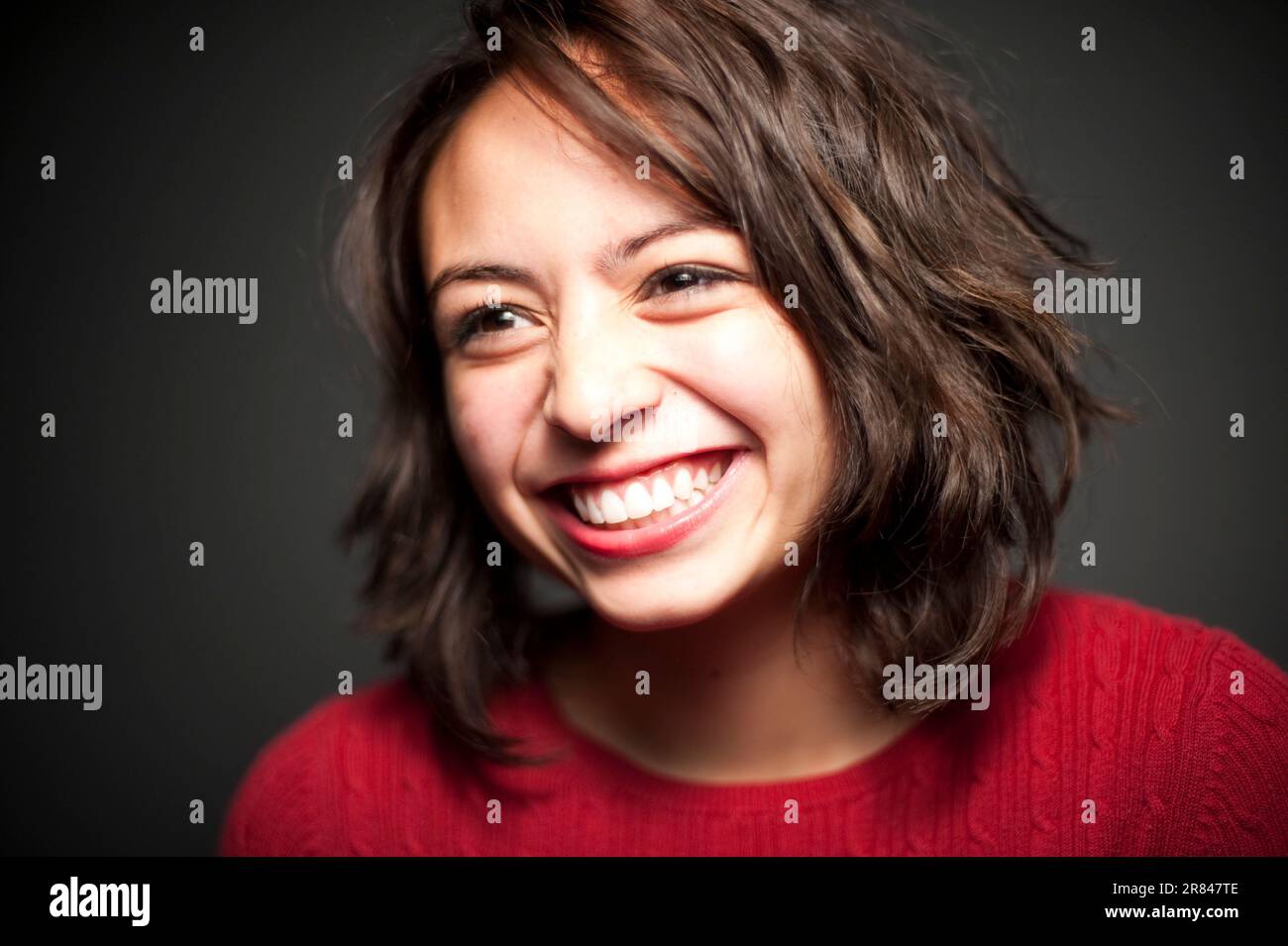 Studio portrait of 15 year old Latina girl laughing Stock Photo - Alamy