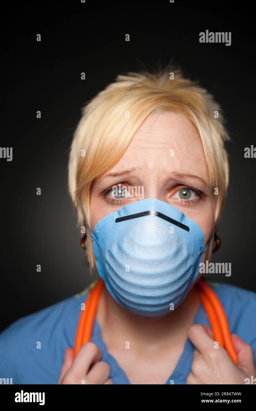 Studio portrait of a 32 years old Caucasian woman wearing a protective mask. Stock Photo