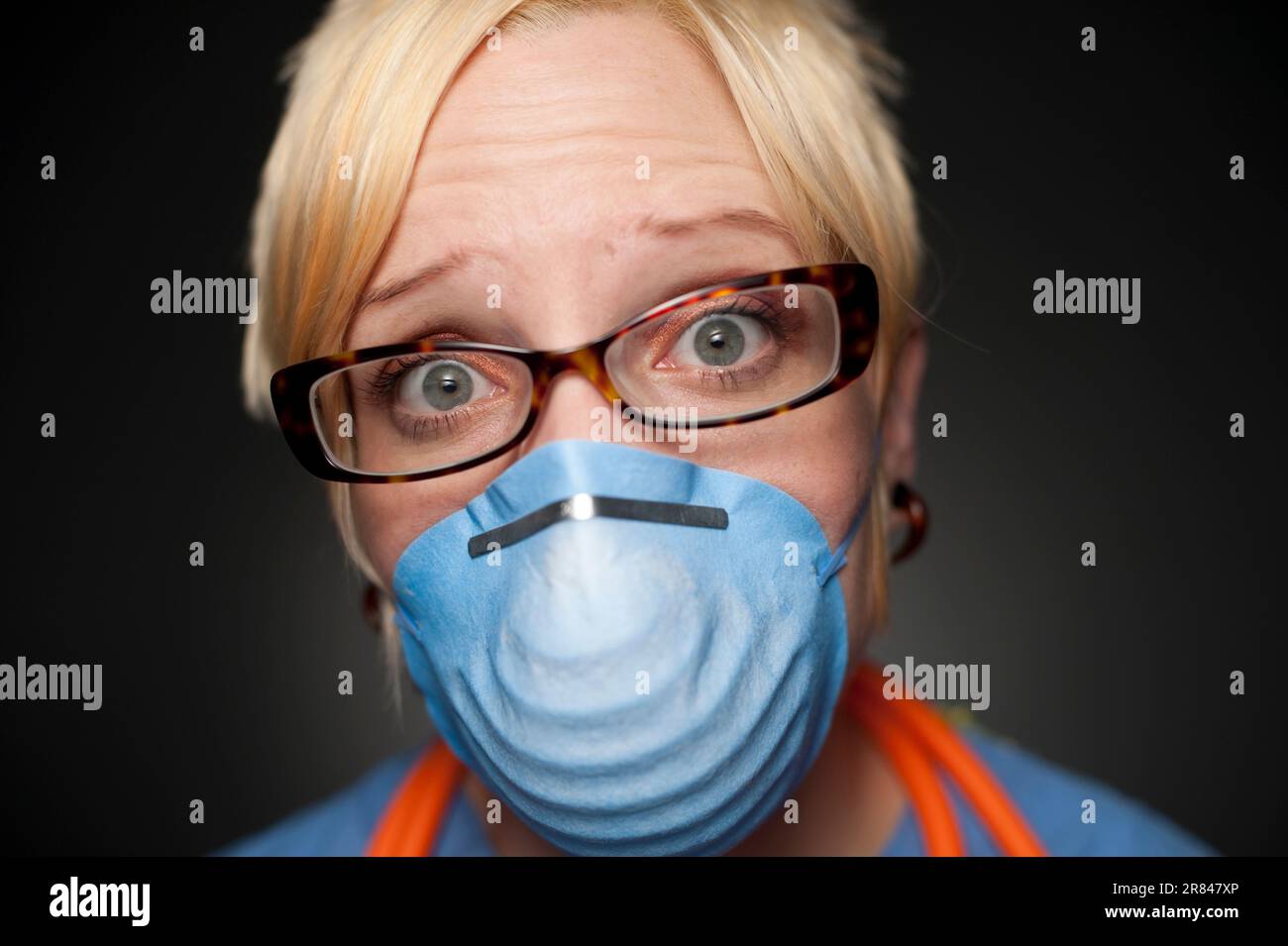 Studio portrait of a 32 years old Caucasian woman wearing a protective mask. Stock Photo