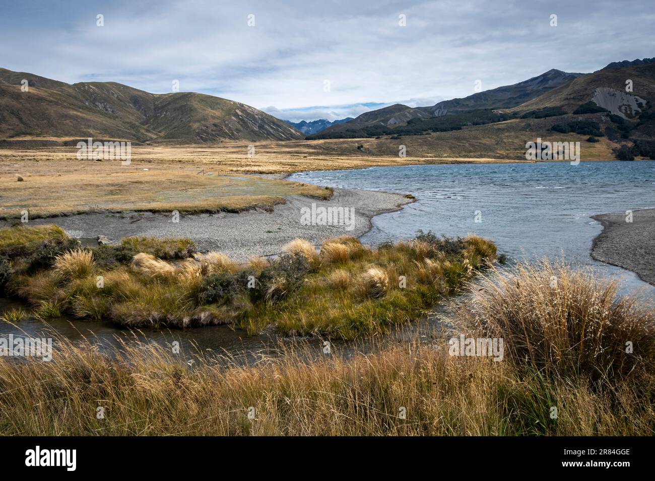 Tussock covered plains and mountains, Lake Tennyson, near Hanmer Springs, Canterbury, South Island, New Zealand Stock Photo